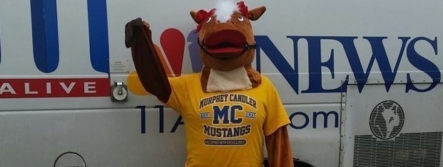 PICTURE OF MUSTANG MASCOT AND 11 ALIVE NEWS VAN